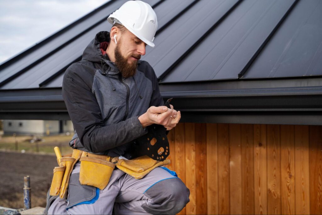 image of a roof installer fixing gutter guards